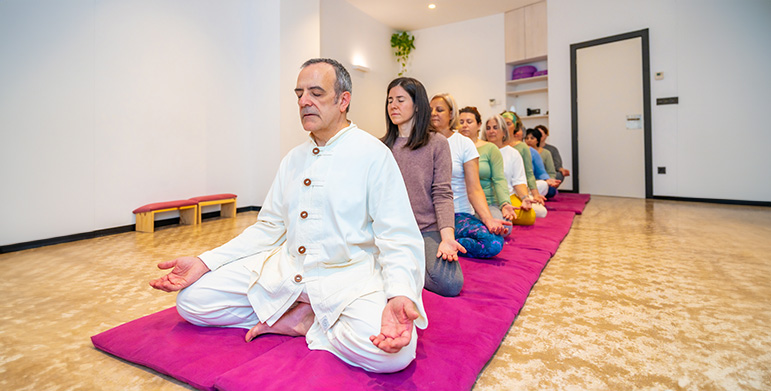 Yoga guru guiding meditation session in Indian ashram