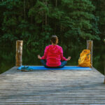 Wellness traveler practicing yoga at a sustainable retreat in India