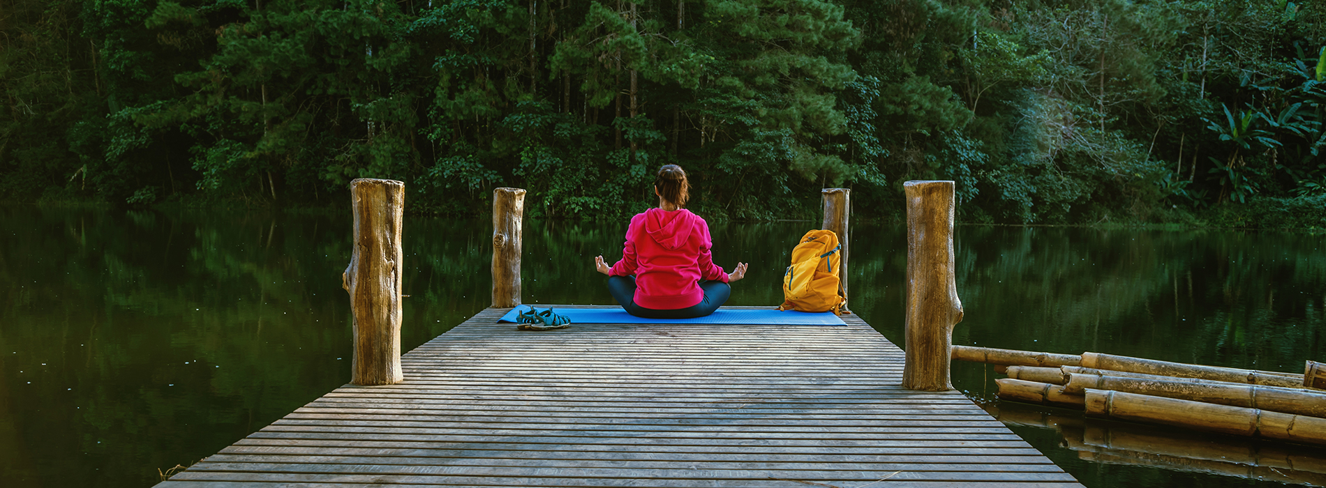 Wellness traveler practicing yoga at a sustainable retreat in India