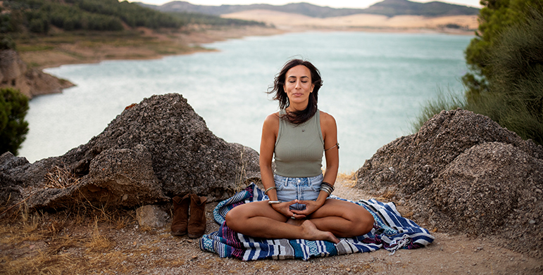 Traveler practicing mindfulness meditation at an Indian wellness retreat