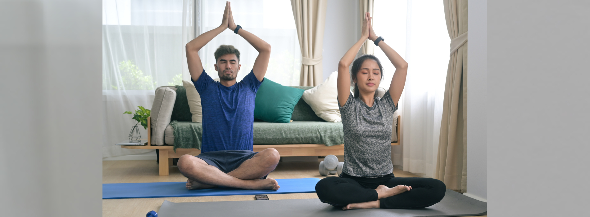 Certified yoga instructor guiding a student at home in Noida
