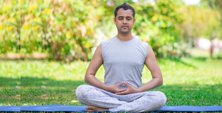 Yoga student experiencing health benefits with a certified yoga instructor in Noida